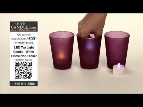 Purple glass cylinder candle holder with a variety of tea lights