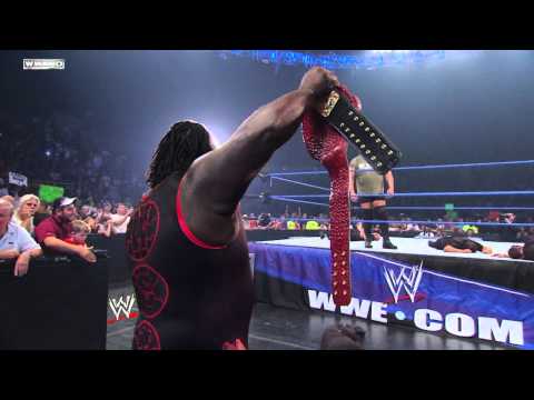 Friday Night SmackDown - Big Show chokeslams Mark Henry through the announce table