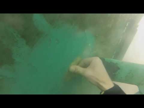 Patching the hull of a boat in the water