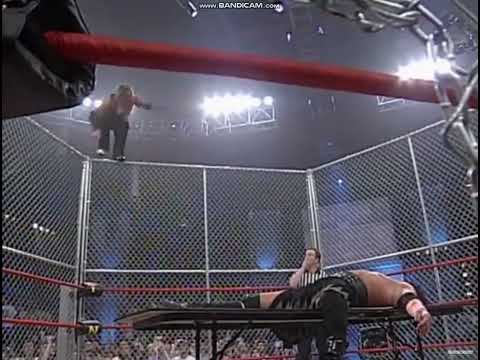 Jeff Hardy misses Raven and crashes from top of cage through table
