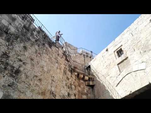 A Shofar blowing on the walls of the Old City of Jerusalem. Zion Gate, Israel