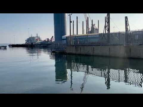 Clear water in Portland Harbour, Dorset and views of the Mulberry Harbours