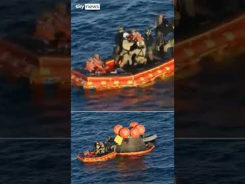 Astronauts emerge from capsule for first time