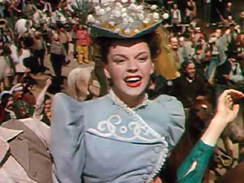 Trailer still of bustling platform choreography, echoing the ensemble energy of the film’s biggest numbers