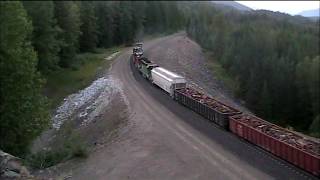 Long BNSF freight train climbs Stampede pass next to old Tunnel #2. 2008.