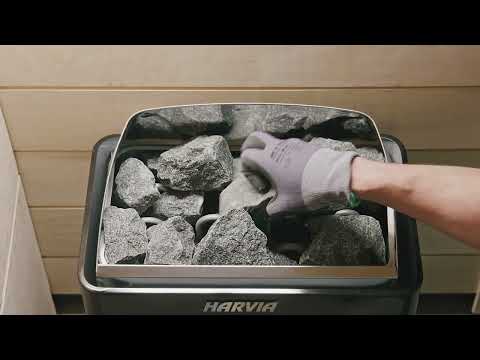 Harvia - Stacking sauna stones into a wall-mounted electric heater