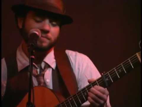 Trailer still: club lighting on a vocalist mid-scream, the documentary’s punk/queercore thread front and center