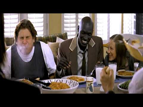 Trailer frame of the existential detectives observing, aligned with light caper woodwinds in the score