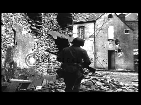 American soldiers walk through the bomb-wrecked streets of St Lo, France. HD Stock Footage