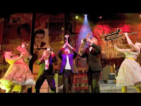 West End trailer still of the Dreamboats and Petticoats youth-club band onstage at the Savoy