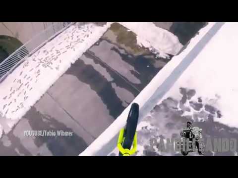 Man cycles along narrow railing above 200m vertical drop along one of tallest dams in Europe