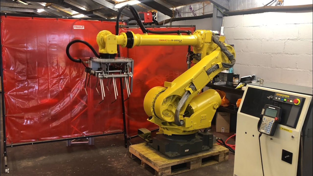 Refurbished Fanuc R2000iA with RJ3iB controller, integrated with a gripper for palletizing