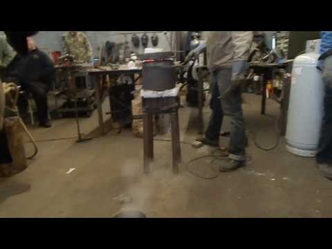 Michael Coffey water casting a copper ingot at Swords Through the Centuries 2016