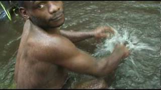 Pygmy swimming in a jungle stream