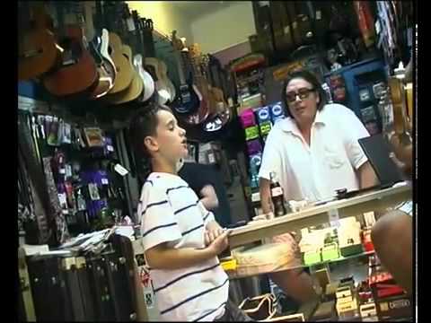 Little boy singing the Blues in a Guitar Store Sounds Great! MUST SEE!