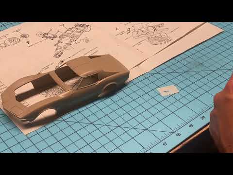 Painting raised emblems on model cars.