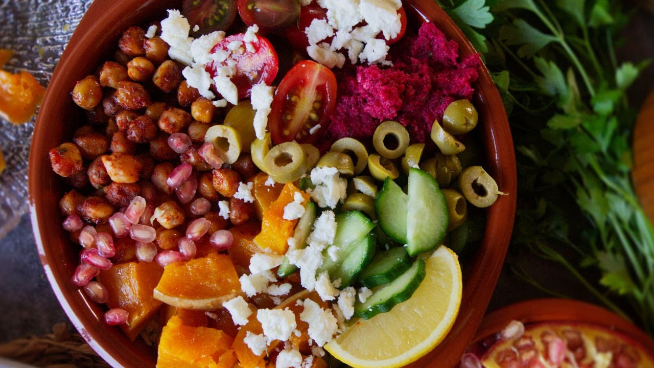 a Mediterranean rice bowl with plenty of colorful salad toppings