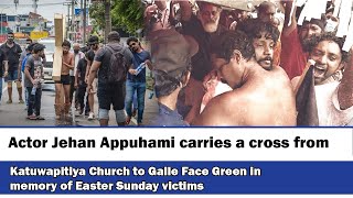 Actor Jehan Appuhami carries a cross from Katuwapitiya Church to Galle Face Green in memory ......