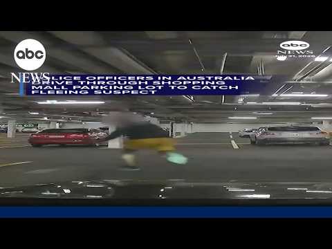 Police officers drive through shopping mall parking lot to catch fleeing suspect