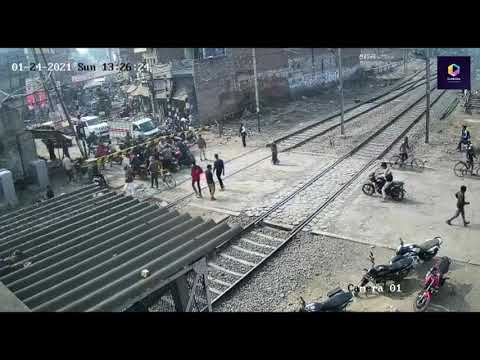 Lucky escape: Indian biker narrowly avoids being smashed by oncoming train