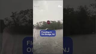 Car drives through floodwaters in New Jersey
