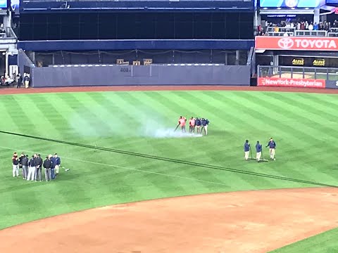 Yankee Stadium grounds crew tries to dry the field