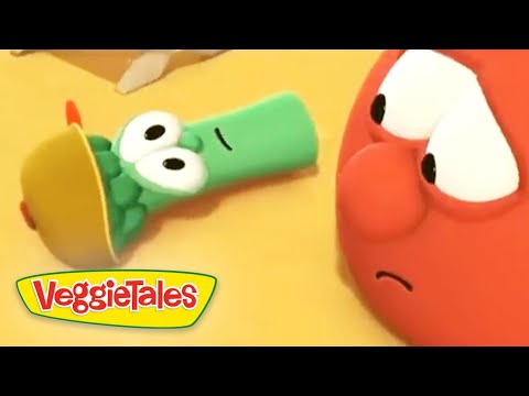 Green veggie wearing a brown hat lies on its side while a red, anxious-looking veggie watches; VeggieTales logo in the corner.