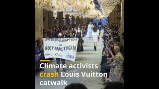 Climate activists crash Louis Vuitton catwalk