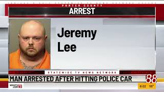 Man arrested after hitting police car