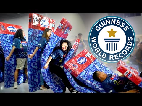 NEW: Longest Human Mattress Dominoes EVER! - Guinness World Records