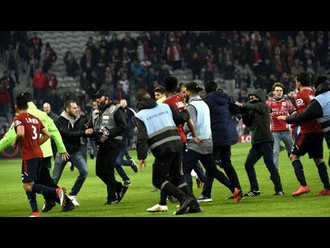 Greek club PAOK owner invades pitch armed, Lille fans attack players