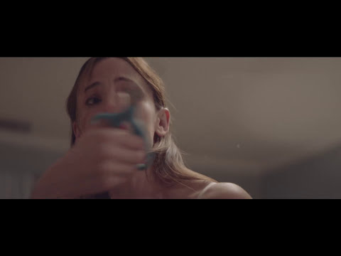 Trailer frame of empty suburban streets and the Pacific beyond — indie cuts playing the teen world