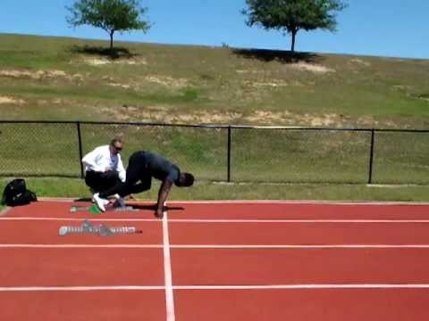 Akwasi Frimpong receiving starting blocks tips from world-class coach Wendell Prince @ Olympic Camp