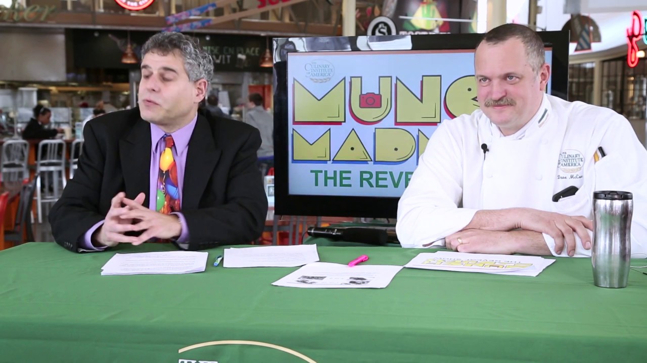 Two administrators of the CIA Munch Madness contest at a table.