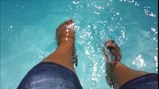 beautiful feet in swimming pool water