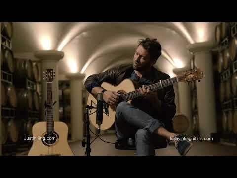 Justin King plays a Kalavinka guitar in a wine cellar.
