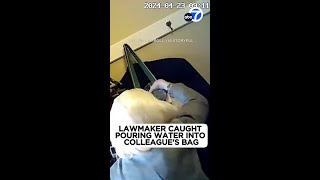 Lawmaker caught pouring water into colleague's bag