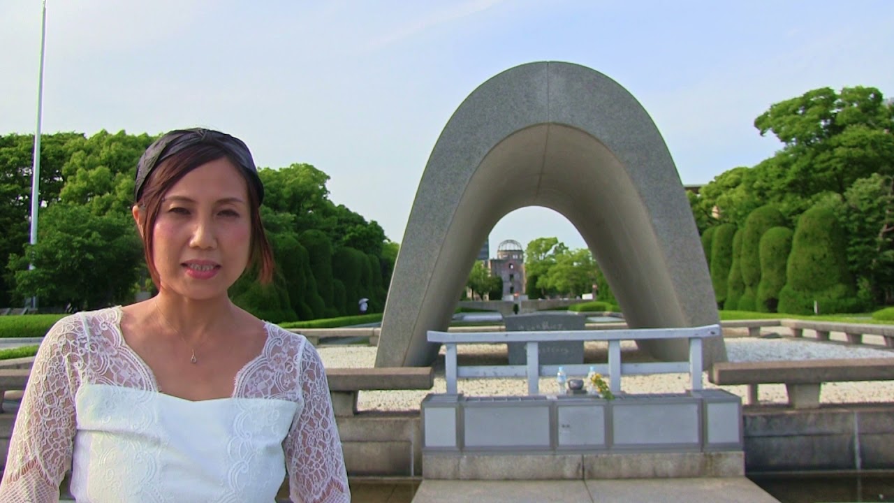 A tourist solemnly pays homage at the Cenotaph for A-Bomb Victims, sharing recollections of the incident.
