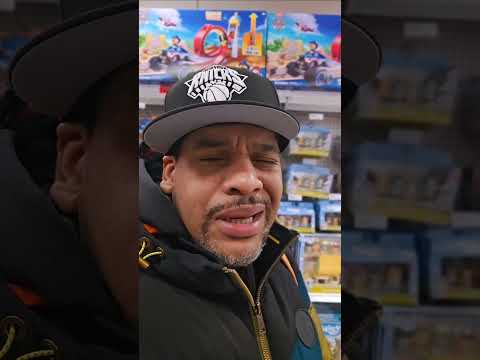 A Grown man buying toys IN NEW YORK CITY , St. Laz