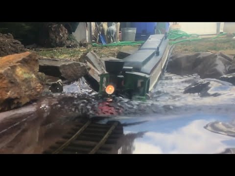 MODEL TRAIN DRIVES INTO A FLOOD