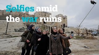 Taking selfies amid the ruins of Aleppo