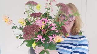 Arranging autumn flowers in a narrow necked vase