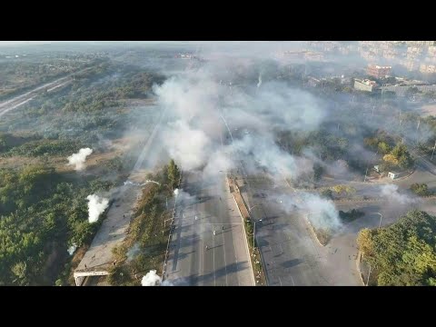Drone images show police firing tear gas at supporters of ex-PM Khan | AFP
