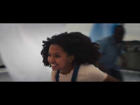 Trailer end card with pastel cosmic lettering and New York blocks behind