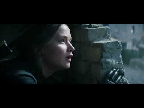Mockingjay – Part 1 trailer frame: Katniss turns toward camera as the rebellion gathers