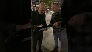 Paul Kelly signs autograph for fan in Melbourne