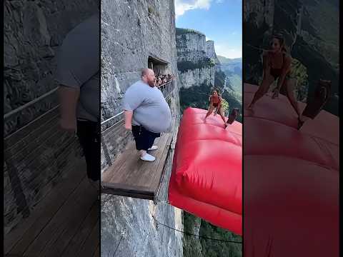 Cliff airbag is wild! 😱🔥 Guy jumps, girl flies! #ScaryRide #TravelWonder