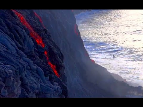 LAVA FLOW OCEAN ENTRY with bodysurfer in the waves