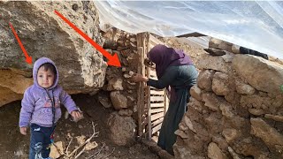 a Mother in the mountains: building the entrance of the shelter with stone and flowers straw