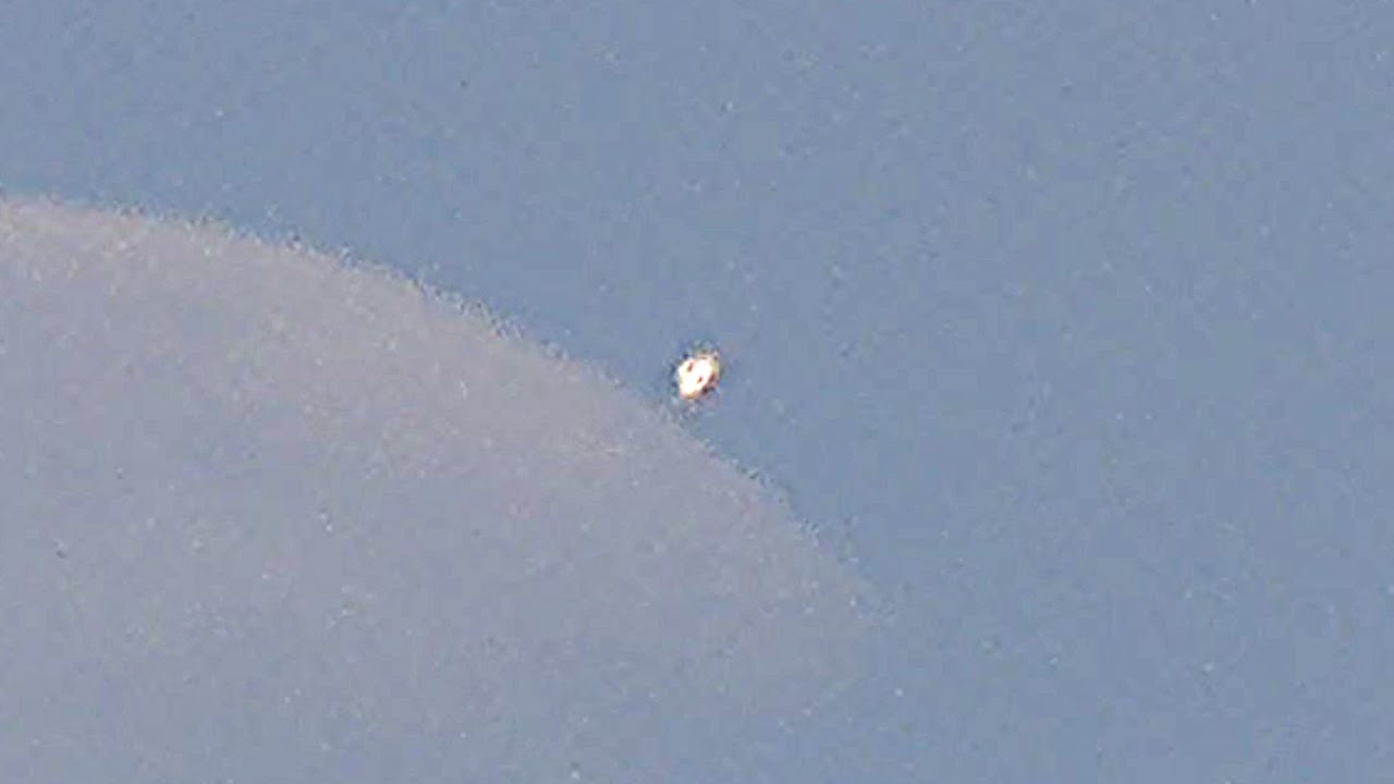 Shining UFO flies during my daytime filming of the Moon over Moscow.
